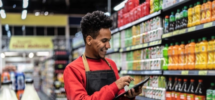 Businessman checking inventory in a digital tablet at a supermarket