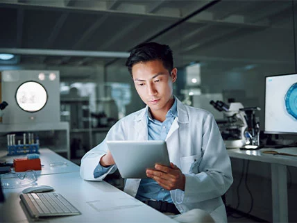 Male Asian-American computer programmer working on robotics and AI software